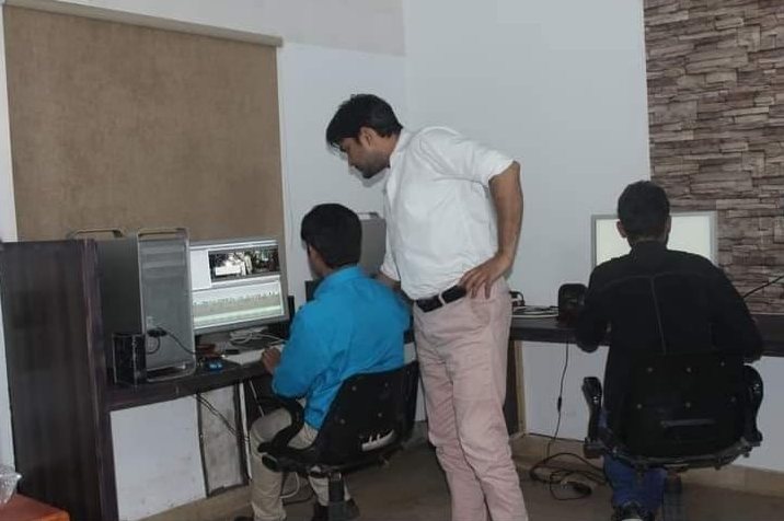 In an edit suite or control room, photo 1